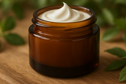 Amber cosmetic jar filled with white cream with a natural background